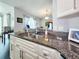 Kitchen sink with granite countertops overlooking dining room and natural lighting at 8442 Pinewood Ave, Brooksville, FL 34613