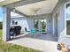 Covered patio with outdoor furniture and grill, perfect for entertaining guests at 8442 Pinewood Ave, Brooksville, FL 34613