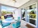 Outdoor patio featuring a glass table with four chairs and sliding glass doors at 8442 Pinewood Ave, Brooksville, FL 34613