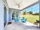 Open patio with a glass table and chairs overlooking the spacious backyard at 8442 Pinewood Ave, Brooksville, FL 34613