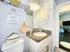 This powder room features a pedestal sink and a decorative mirror at 8442 Pinewood Ave, Brooksville, FL 34613