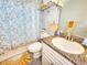 This powder room has updated fixtures and a decorative Paris-themed shower curtain at 8442 Pinewood Ave, Brooksville, FL 34613