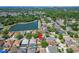 Aerial view showcasing the neighborhood and a nearby lake in a desirable community at 9504 Laurel Ledge Dr, Riverview, FL 33569