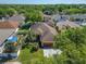 Aerial view showcasing a beautiful home with a well-maintained lawn and mature trees at 9504 Laurel Ledge Dr, Riverview, FL 33569