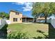 Expansive backyard featuring lush green grass, a mature tree, and a screened patio at 9504 Laurel Ledge Dr, Riverview, FL 33569