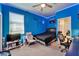 A blue bedroom with a ceiling fan, LED strip lights, and a queen bed at 9504 Laurel Ledge Dr, Riverview, FL 33569
