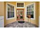 Close-up of the front door with decorative glass, flanked by windows, enhancing the home's curb appeal and entrance at 9504 Laurel Ledge Dr, Riverview, FL 33569