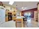 Open kitchen overlooking the living room with breakfast bar, modern appliances, and wood cabinets at 9504 Laurel Ledge Dr, Riverview, FL 33569