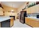 Spacious kitchen featuring stainless steel refrigerator and view to the dining area at 9504 Laurel Ledge Dr, Riverview, FL 33569