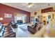 Cozy living room features comfortable seating, a large window overlooking the backyard, and a ceiling fan, creating a relaxing space at 9504 Laurel Ledge Dr, Riverview, FL 33569