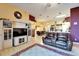 Spacious living room featuring an entertainment center, leather sofa, and rug at 9504 Laurel Ledge Dr, Riverview, FL 33569