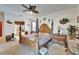 Main bedroom featuring a decorative ceiling fan, carpet floors, and ensuite bath with soaking tub at 9504 Laurel Ledge Dr, Riverview, FL 33569