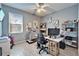 A gray office featuring a desk, ceiling fan, and workout equipment at 9504 Laurel Ledge Dr, Riverview, FL 33569