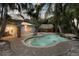Aerial view of a lush backyard oasis with pool, tiki hut, and ample patio space at 102 Crestwood Ln, Largo, FL 33770