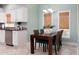 Charming dining area with natural light, table for four, and modern appliances at 102 Crestwood Ln, Largo, FL 33770