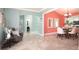 An open-concept dining room, featuring neutral tiling, with a view into a light and airy living room space at 102 Crestwood Ln, Largo, FL 33770