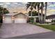 Charming single-Gathering home showcasing well-manicured landscaping and mature palm trees at 102 Crestwood Ln, Largo, FL 33770