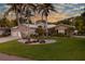 Charming single-Gathering home showcasing well-manicured landscaping and mature palm trees at 102 Crestwood Ln, Largo, FL 33770