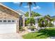 Charming exterior of a single-Gathering home with manicured lawn, stone accents, and a paved driveway leading to a two-car garage at 102 Crestwood Ln, Largo, FL 33770