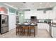 Modern kitchen features stainless appliances, breakfast bar, and tiled backsplash at 102 Crestwood Ln, Largo, FL 33770