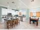 Gourmet kitchen with white cabinetry, stainless steel appliances, and a breakfast bar at 102 Crestwood Ln, Largo, FL 33770