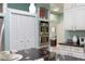Kitchen showcases stainless steel double ovens, ample storage with white cabinets, and granite countertops at 102 Crestwood Ln, Largo, FL 33770