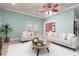 Bright living room featuring comfortable seating and a decorative glass coffee table at 102 Crestwood Ln, Largo, FL 33770