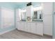 Main bathroom has double sink vanity with granite counters, tile floors, and custom cabinets at 102 Crestwood Ln, Largo, FL 33770