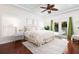 Bright bedroom with ceiling fan, tray ceiling, wood floors, and glass doors that lead to a pool at 102 Crestwood Ln, Largo, FL 33770