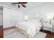 Cozy main bedroom with neutral decor, wood floors, tray ceiling, and natural light at 102 Crestwood Ln, Largo, FL 33770
