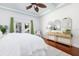Spacious main bedroom boasts hardwood floors, ceiling fan, and sliding door access to the outdoor pool area at 102 Crestwood Ln, Largo, FL 33770