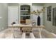 Stylish home office featuring custom built-ins, a modern desk, and neutral decor at 102 Crestwood Ln, Largo, FL 33770