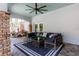Stylish outdoor seating area with plush cushions, decorative pillows, and an overhead fan at 102 Crestwood Ln, Largo, FL 33770