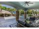 Elegant outdoor patio with a comfortable seating area, pool views, and decorative columns at 102 Crestwood Ln, Largo, FL 33770
