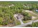 Aerial shot of home nestled in a lush green landscape, surrounded by trees offering ultimate privacy at 10423 Sand Lark Ave, Weeki Wachee, FL 34614