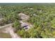 An aerial shot of home nestled amidst a dense forest, showcasing its peaceful, secluded setting at 10423 Sand Lark Ave, Weeki Wachee, FL 34614