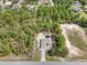 Aerial view of home with long driveway surrounded by green landscape, near paved street at 10423 Sand Lark Ave, Weeki Wachee, FL 34614