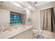 Clean bathroom with single sink, vanity and shower with decorative curtain at 10423 Sand Lark Ave, Weeki Wachee, FL 34614