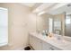 Bathroom with double sink vanity, large mirror, and tiled shower at 10423 Sand Lark Ave, Weeki Wachee, FL 34614