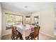 Bright dining room with large window overlooking backyard at 10423 Sand Lark Ave, Weeki Wachee, FL 34614