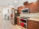 Efficient kitchen layout with stainless steel appliances and seamless access to the laundry room at 10423 Sand Lark Ave, Weeki Wachee, FL 34614