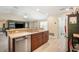 Open kitchen with stainless steel appliances, granite countertops, and wood cabinets at 10423 Sand Lark Ave, Weeki Wachee, FL 34614