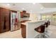 Modern kitchen with stainless steel appliances, granite countertops, and a breakfast bar at 10423 Sand Lark Ave, Weeki Wachee, FL 34614