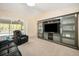 Comfortable living room with an entertainment center and sliding glass doors to the lanai at 10423 Sand Lark Ave, Weeki Wachee, FL 34614