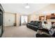 Cozy living room featuring plush seating and an open layout leading to the kitchen area at 10423 Sand Lark Ave, Weeki Wachee, FL 34614