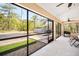 Enclosed patio with ceiling fan and view of the backyard and shed at 10423 Sand Lark Ave, Weeki Wachee, FL 34614