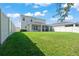 Expansive backyard features lush green grass and a covered patio perfect for outdoor entertaining at 10814 Whitland Grove Dr, Riverview, FL 33578