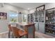 Custom-built bar with wood countertop, comfortable seating, and display shelves showcasing liquor collection and decor at 10814 Whitland Grove Dr, Riverview, FL 33578