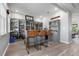 Entertaining space showcasing a full custom bar setup with display cases, seating and convenient layout at 10814 Whitland Grove Dr, Riverview, FL 33578