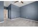 Bedroom with plush carpet, ceiling fan, and view of the doorway and hallway at 10814 Whitland Grove Dr, Riverview, FL 33578